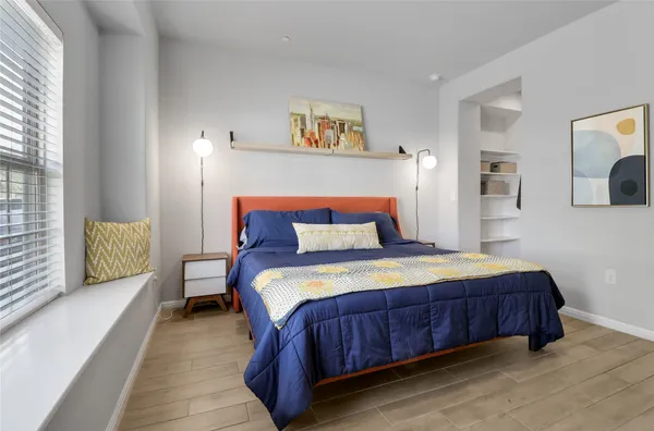 a bedroom with a bed and night stand