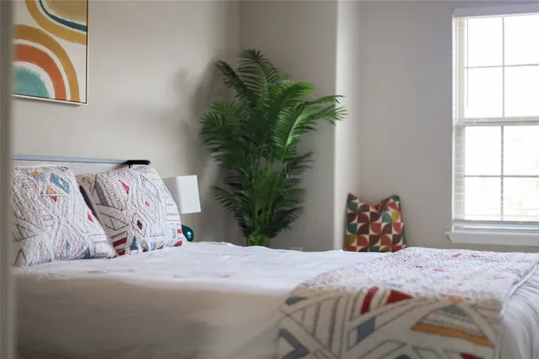 a bedroom with a bed and a window