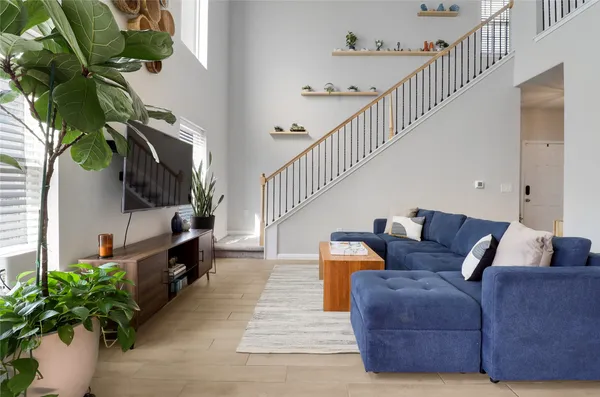 a living room with furniture and a potted plant