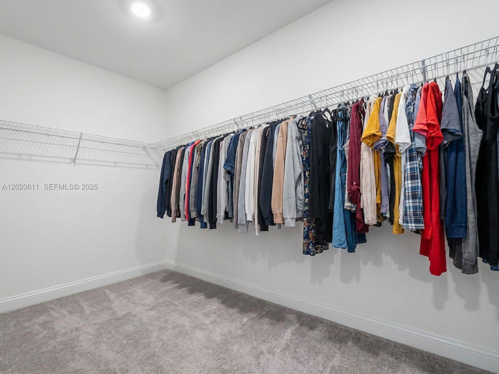 26455 Southwest 148th Avenue Homestead, FL 33032 - Photo 14 of 35 a view of walk in closet with clothes