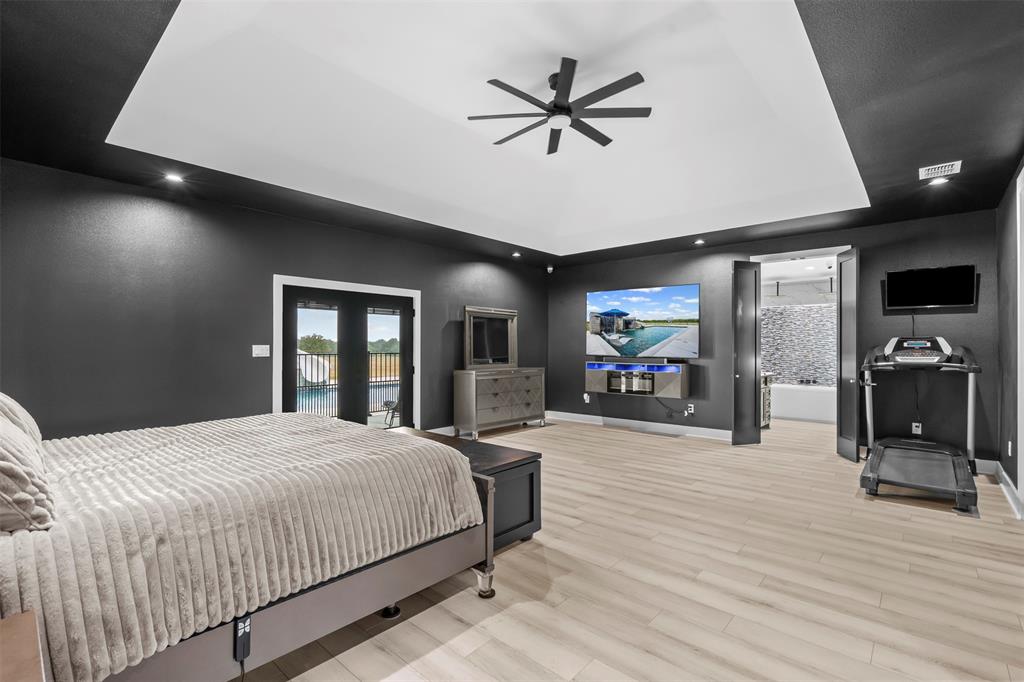 9700 Nix Road Tolar, TX 76476 - Photo 11 of 39 a bedroom with a bed and a flat tv screen on dresser