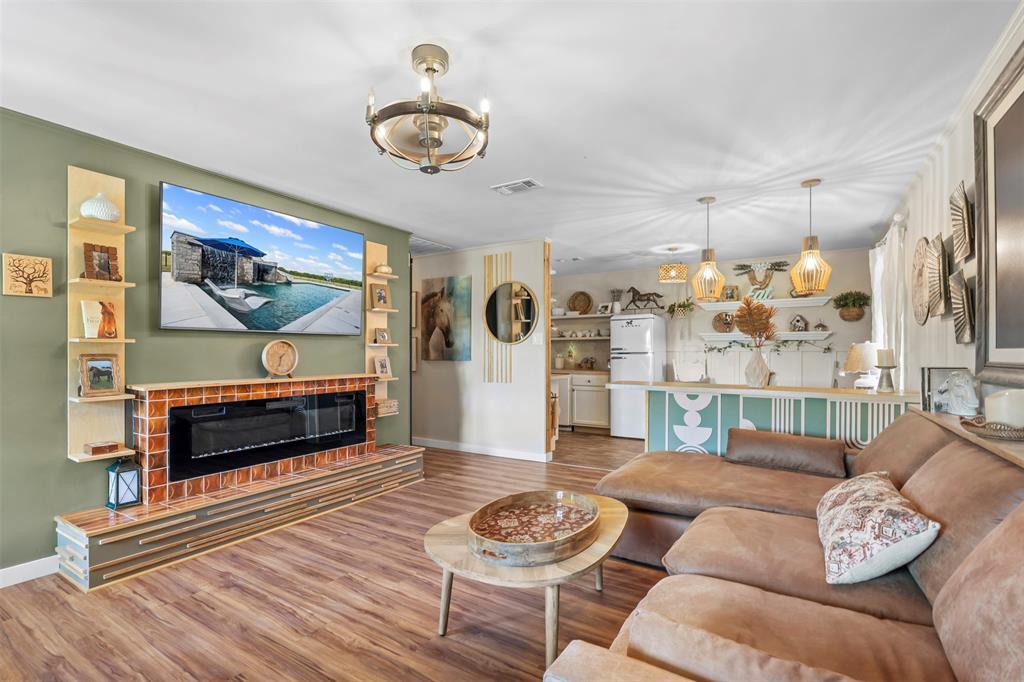 9700 Nix Road Tolar, TX 76476 - Photo 34 of 39 a living room with furniture and a flat screen tv