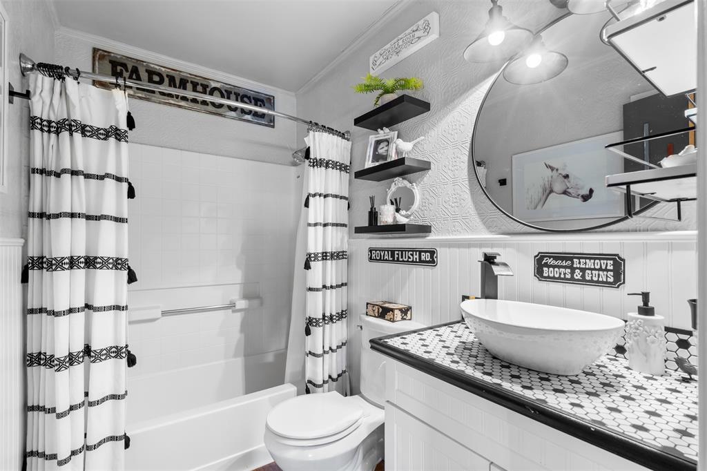 9700 Nix Road Tolar, TX 76476 - Photo 39 of 39 a bathroom with a granite countertop sink mirror vanity and toilet