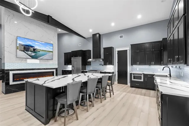 a large kitchen with a table and chairs