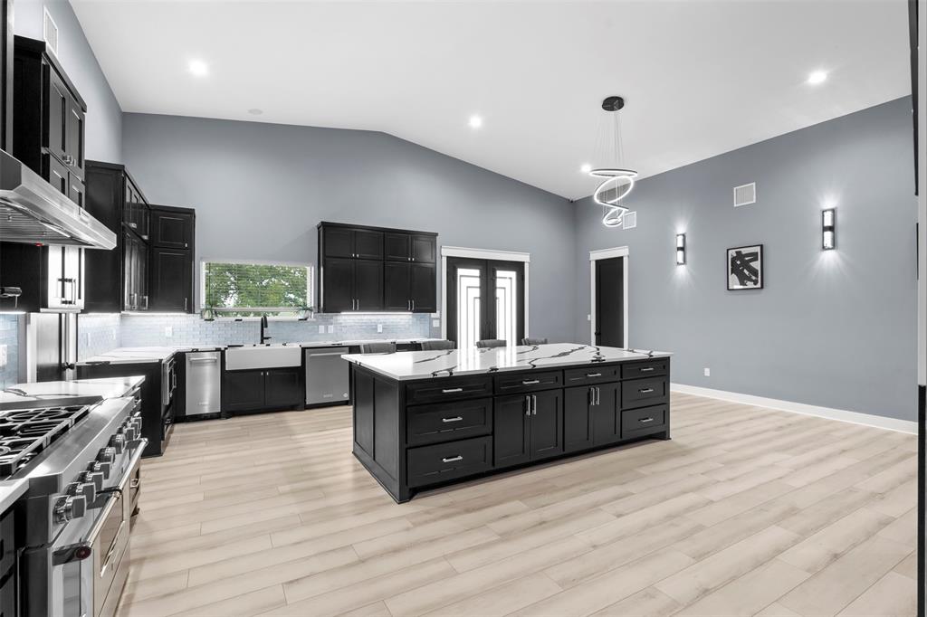 9700 Nix Road Tolar, TX 76476 - Photo 6 of 39 a large kitchen with stainless steel appliances a large counter top a stove and a sink