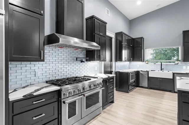 a kitchen with stainless steel appliances kitchen island a stove and a refrigerator
