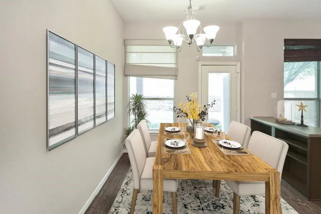 a view of a dining room with furniture and a chandelier