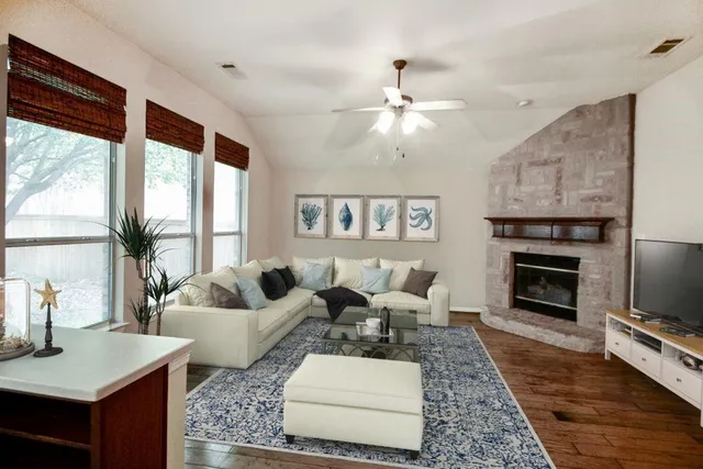 a living room with furniture fireplace and flat screen tv