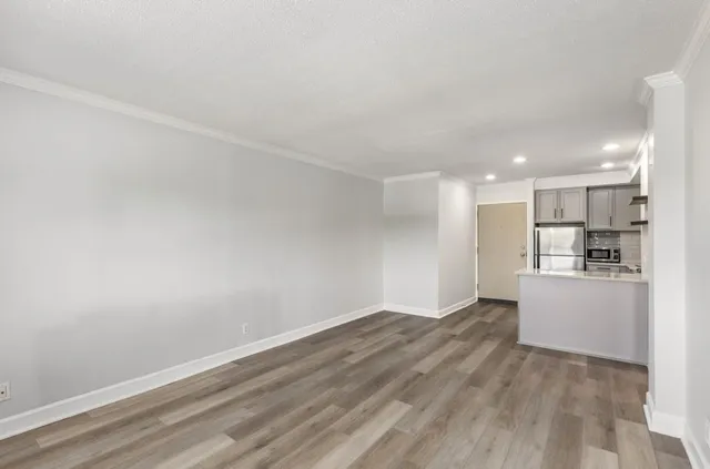a kitchen with stainless steel appliances a refrigerator sink and cabinets