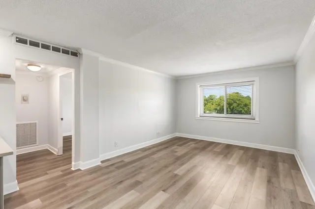 wooden floor in an empty room with a window