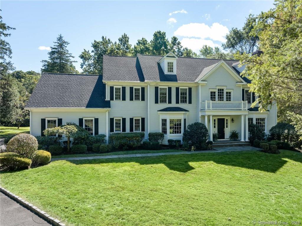 a aerial view of a house next to a big yard and large trees