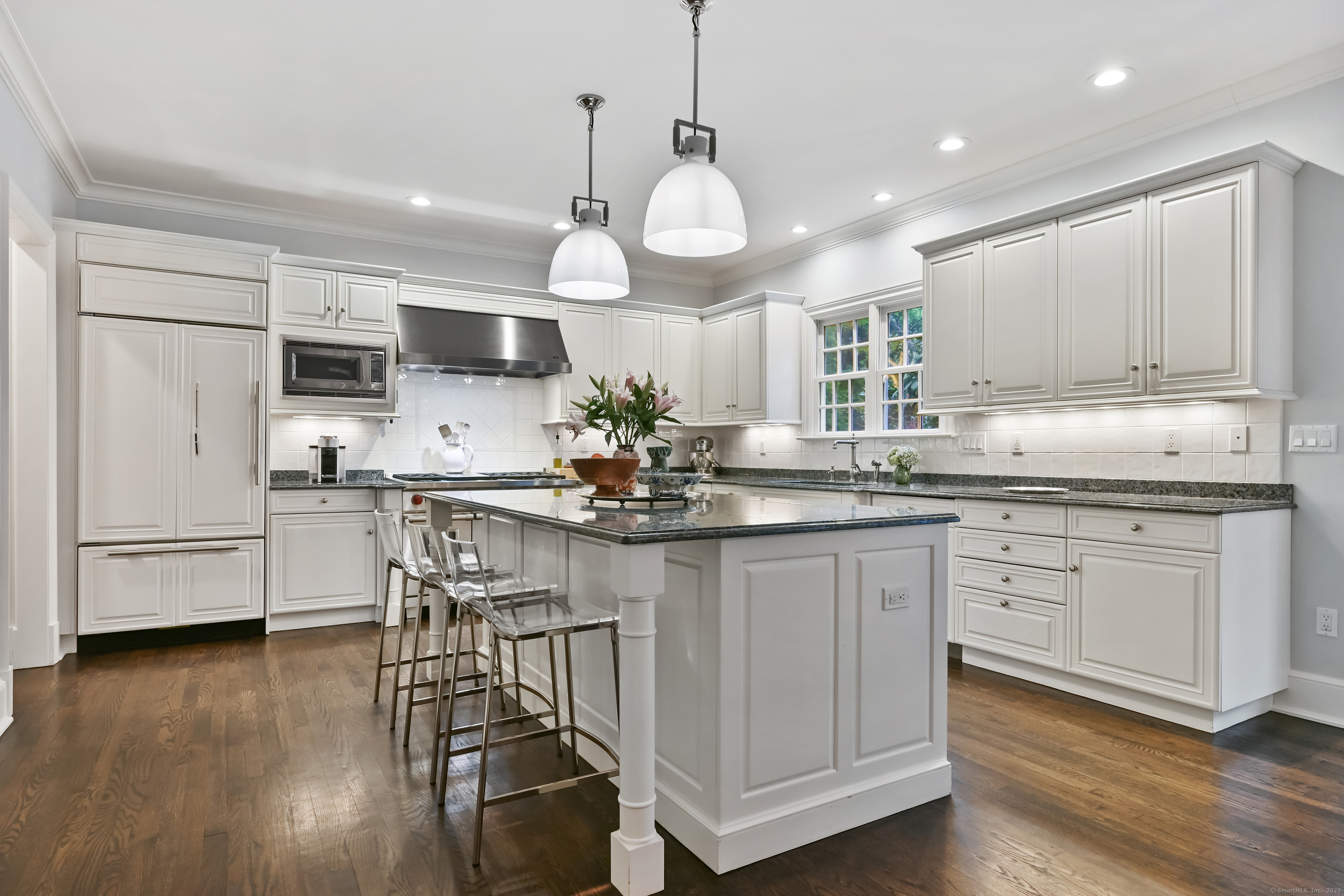 184 Marvin Ridge Road New Canaan, CT 06840 - Photo 11 of 39 a kitchen with stainless steel appliances granite countertop a stove top oven a refrigerator a sink and cabinets with wooden floor