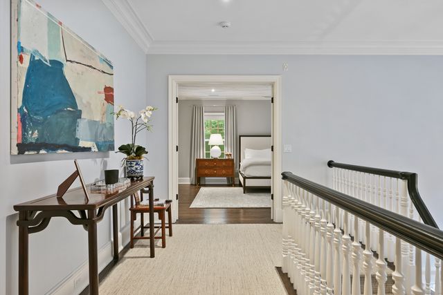 a view of a hallway with couches and white walls