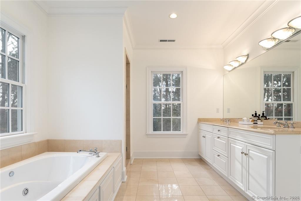184 Marvin Ridge Road New Canaan, CT 06840 - Photo 19 of 39 a bathroom with a tub sink double vanity and windows
