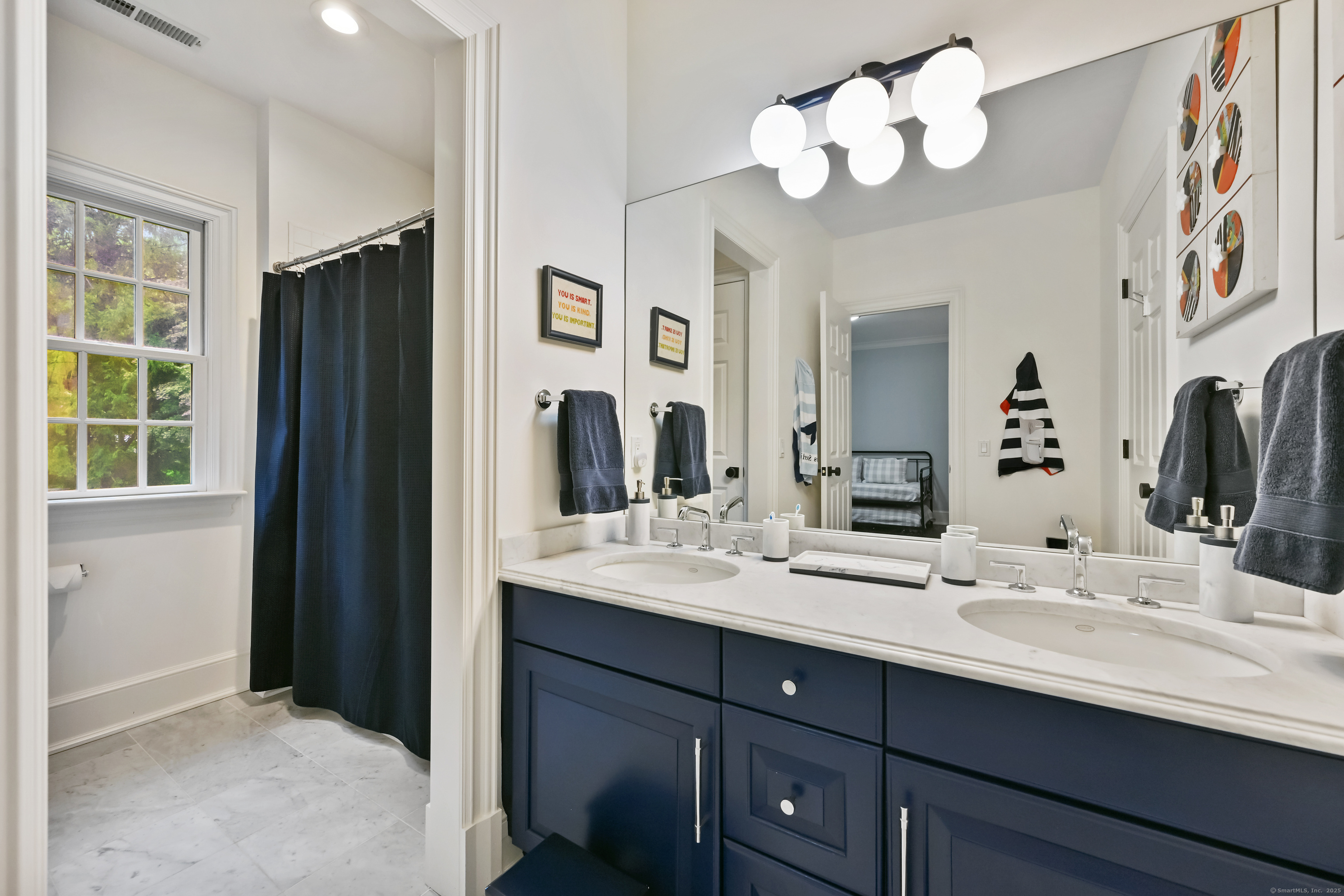 184 Marvin Ridge Road New Canaan, CT 06840 - Photo 22 of 39 a bathroom with double vanity sinks a vanity a lamp and a mirror