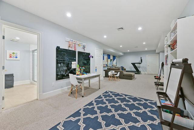 a living room with furniture and a rug