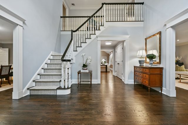 a view of staircase with white walls and wooden floor