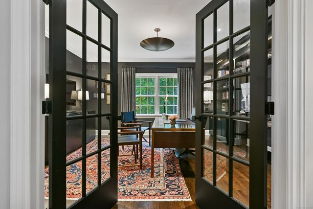 a living room with furniture and a floor to ceiling window