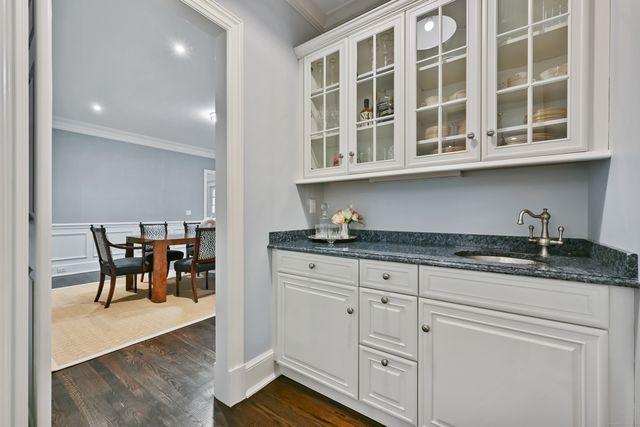 a kitchen with granite countertop white cabinets and appliances