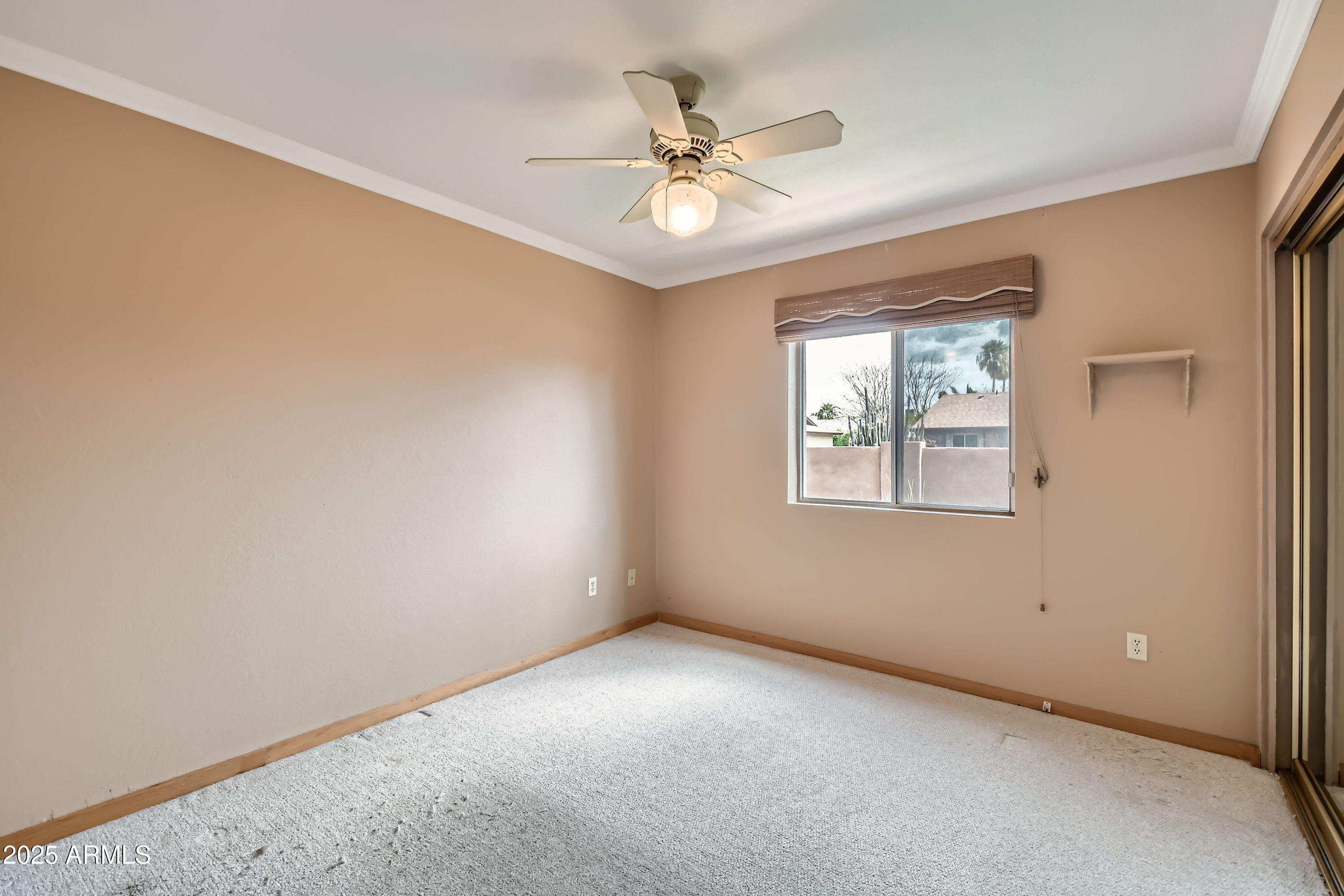 6115 East Spring Road Scottsdale, AZ 85254 - Photo 22 of 29 an empty room with a window and a fan