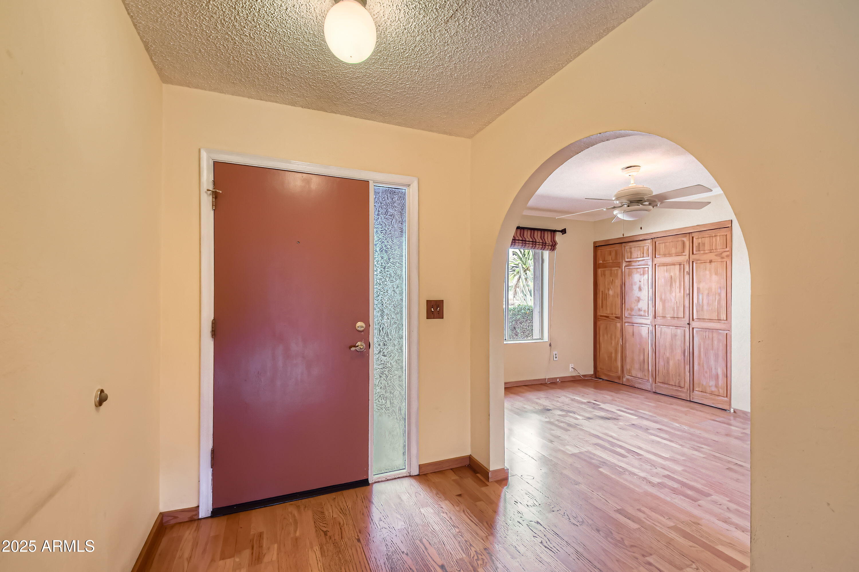 6115 East Spring Road Scottsdale, AZ 85254 - Photo 8 of 29 an empty room with wooden floor and windows