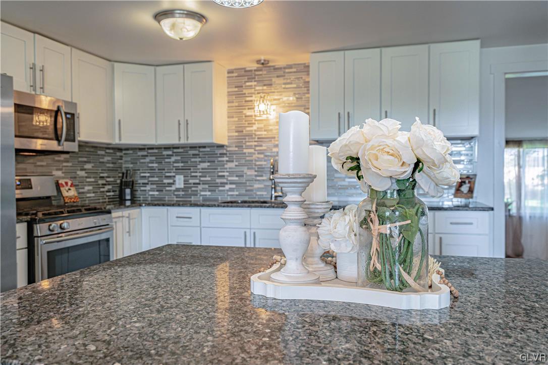 6251 Locust Road Bath, PA 18014 - Photo 12 of 42 a kitchen with a stove a sink cabinetry and a counter top space