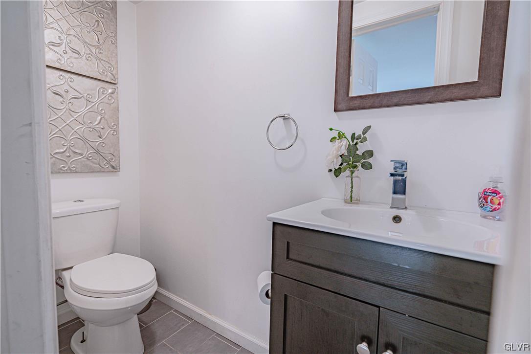 6251 Locust Road Bath, PA 18014 - Photo 22 of 42 a bathroom with a toilet a sink and mirror