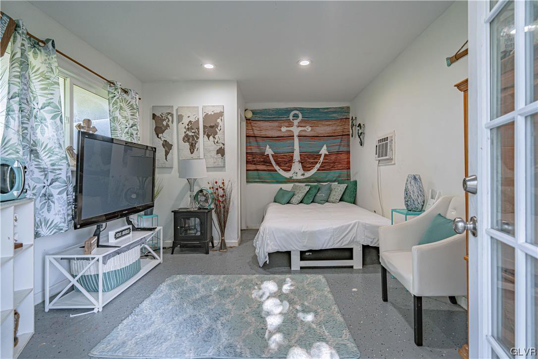 6251 Locust Road Bath, PA 18014 - Photo 34 of 42 a living room with furniture a flat screen tv and floor to ceiling window