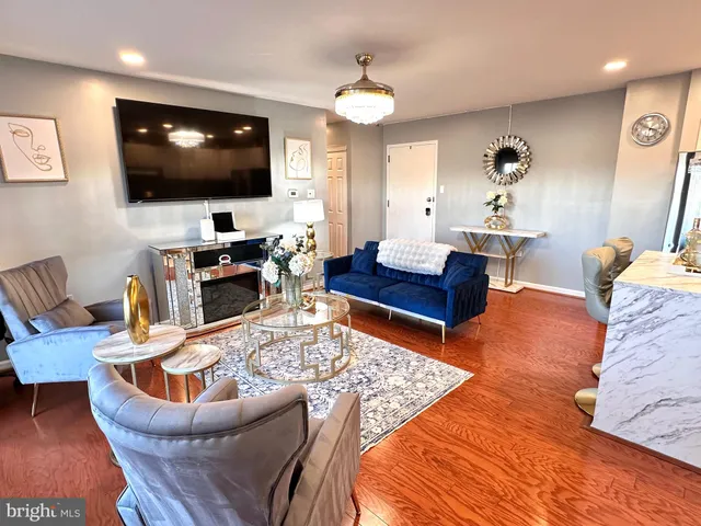 a kitchen with stainless steel appliances a refrigerator a sink a stove a table and chairs