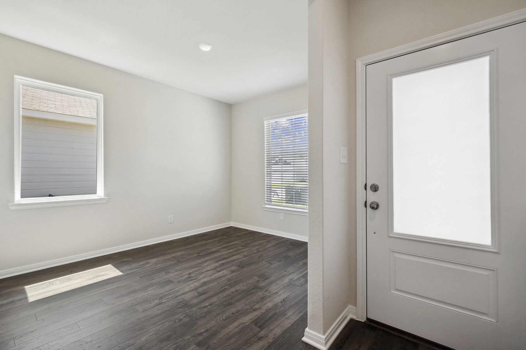 10366 Red Cardinal Drive Cleveland, TX 77328 - Photo 3 of 21 an empty room with wooden floor and windows
