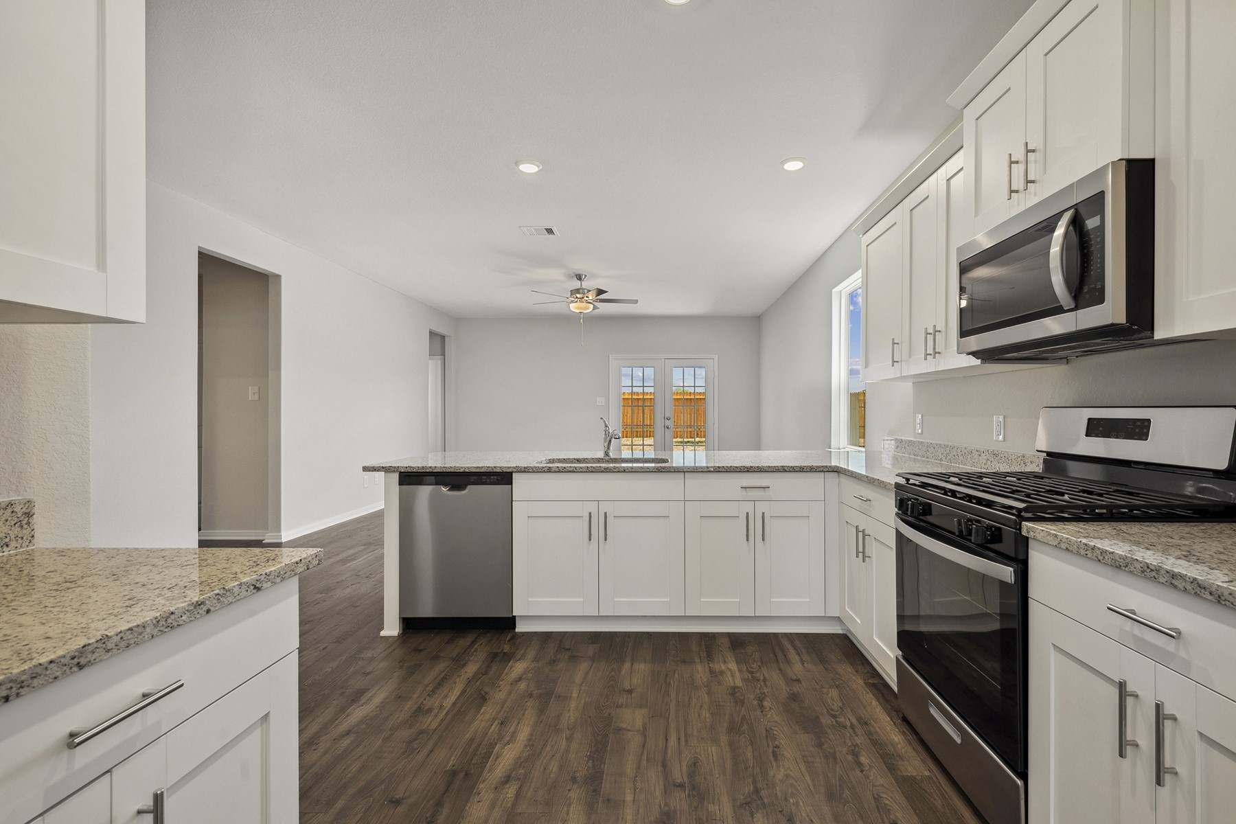 10366 Red Cardinal Drive Cleveland, TX 77328 - Photo 5 of 21 a kitchen with a sink stove and microwave