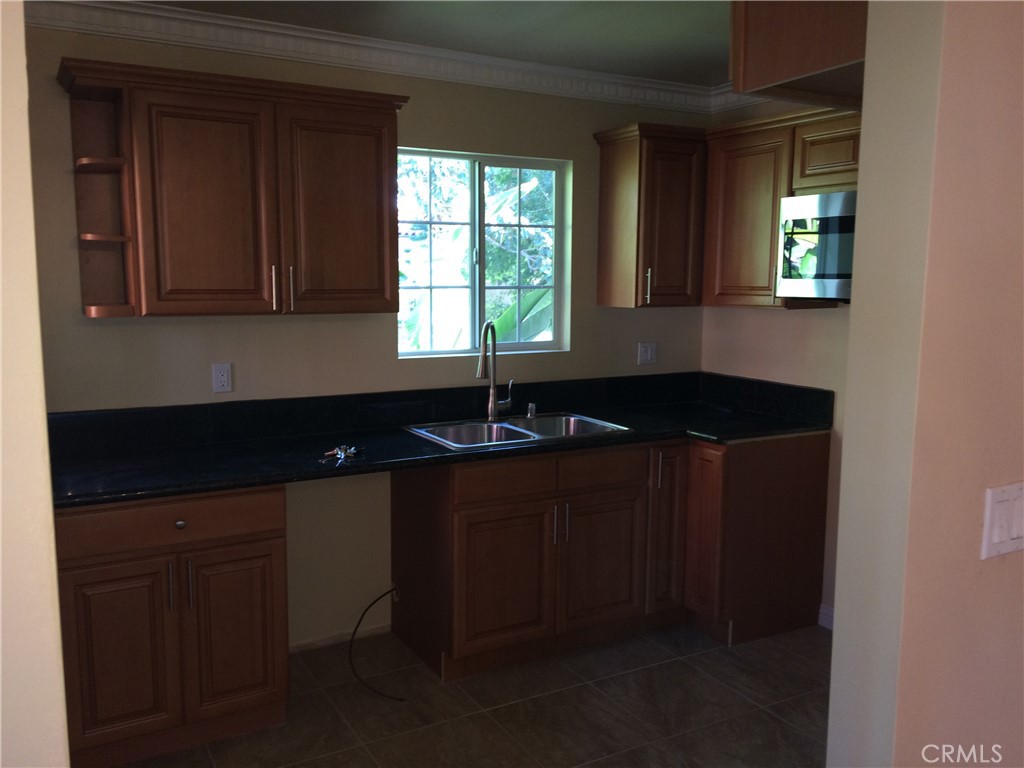 1915-1917 South Orange Drive Los Angeles, CA 90016 - Photo 6 of 11 a kitchen with a sink and a window