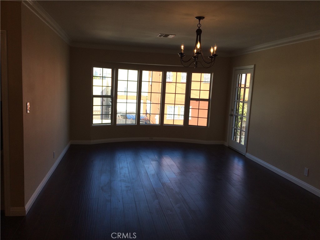 1915-1917 South Orange Drive Los Angeles, CA 90016 - Photo 7 of 11 a view of an empty room window and wooden floor