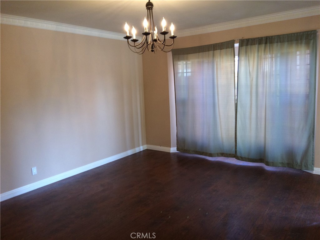 1915-1917 South Orange Drive Los Angeles, CA 90016 - Photo 9 of 11 a view of an empty room with a chandelier fan