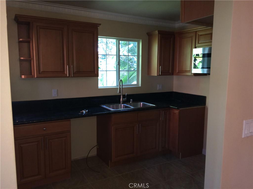 1915-1917 South Orange Drive Los Angeles, CA 90016 - Photo 10 of 11 a kitchen with a sink and a window