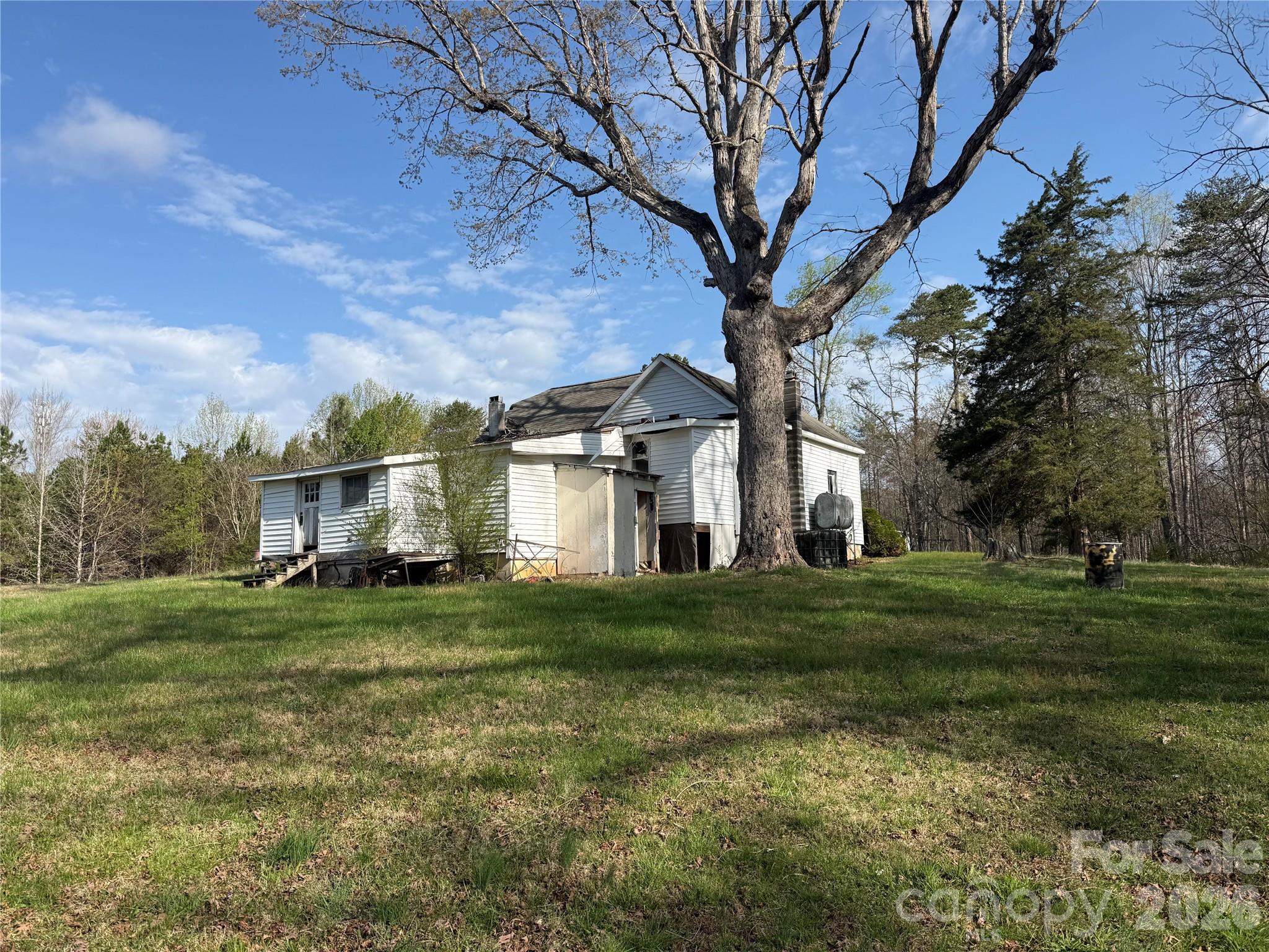 1164 Robert C Kellam Road Pinnacle, NC 27043 - Photo 14 of 48 a view of a big yard in front of a house with large trees