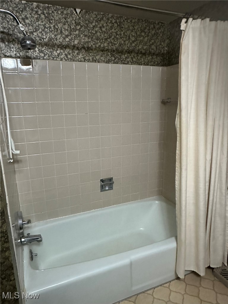 97 West Howe Road Tallmadge, OH 44278 - Photo 26 of 35 Bathroom with tile patterned flooring and shower / bath combination with curtain