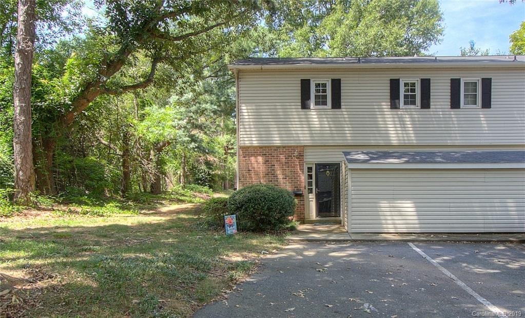 5941 Quail Hollow Road, Unit A Charlotte, NC 28210 - Photo 2 of 26 a front view of a house with a yard and garage