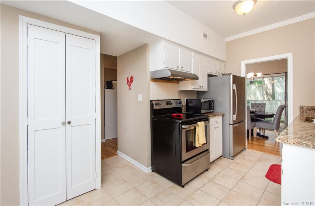 5941 Quail Hollow Road, Unit A Charlotte, NC 28210 - Photo 11 of 26 a kitchen with stainless steel appliances a refrigerator sink and cabinets