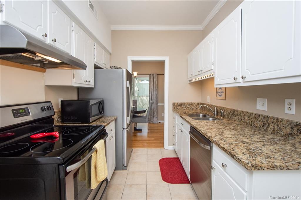 5941 Quail Hollow Road, Unit A Charlotte, NC 28210 - Photo 12 of 26 a kitchen that has a sink and a stove