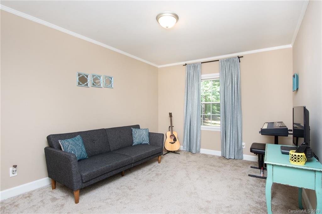 5941 Quail Hollow Road, Unit A Charlotte, NC 28210 - Photo 16 of 26 a living room with furniture and a flat screen tv