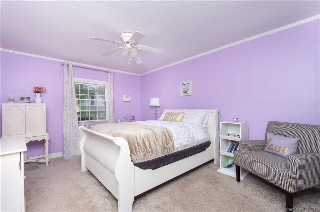 5941 Quail Hollow Road, Unit A Charlotte, NC 28210 - Photo 18 of 26 a spacious bedroom with a bed and a couch
