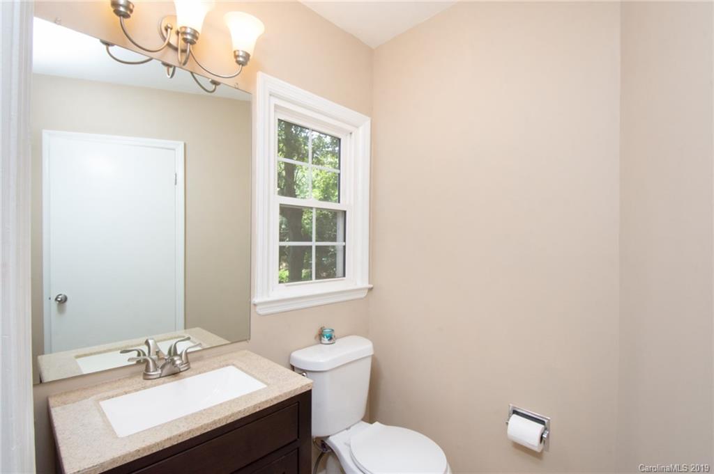 5941 Quail Hollow Road, Unit A Charlotte, NC 28210 - Photo 23 of 26 a bathroom with a sink a toilet and a mirror