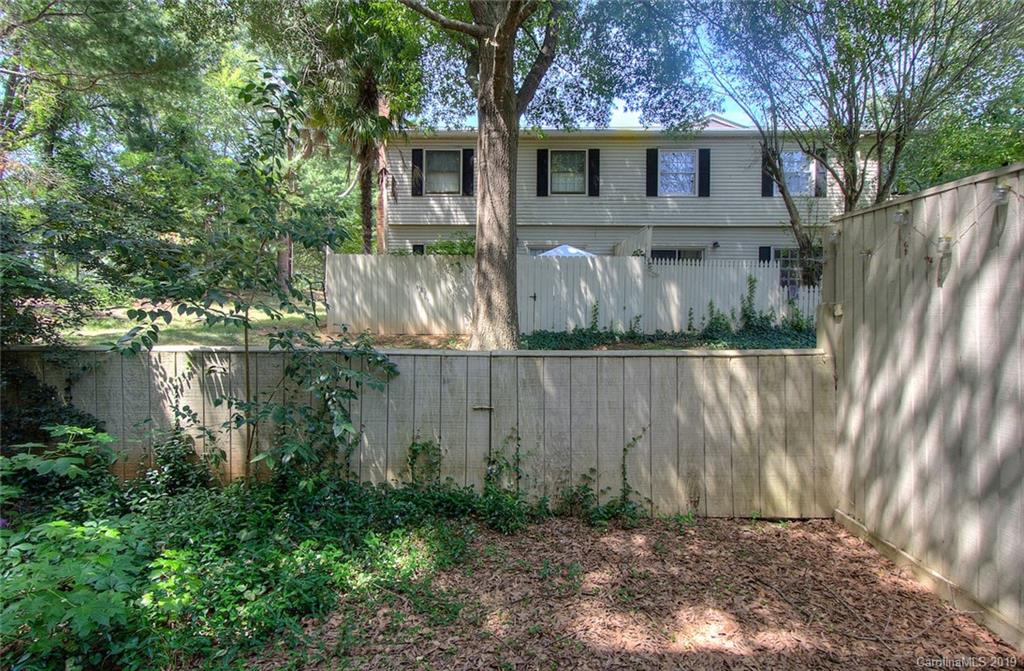 5941 Quail Hollow Road, Unit A Charlotte, NC 28210 - Photo 25 of 26 a backyard of a house with lots of green space