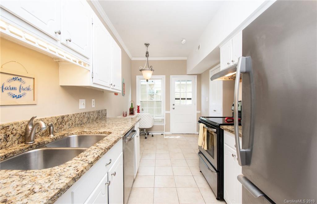 5941 Quail Hollow Road, Unit A Charlotte, NC 28210 - Photo 10 of 26 a kitchen with a sink and a stove top oven