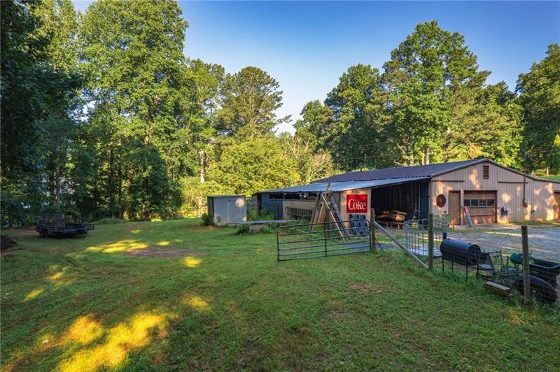 365 Russell King Lane Canton, GA 30115 - Photo 8 of 22 a view of a backyard with table and chairs and a large tree