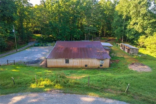 an aerial view of a house with a yard lake lake and mountain view in back