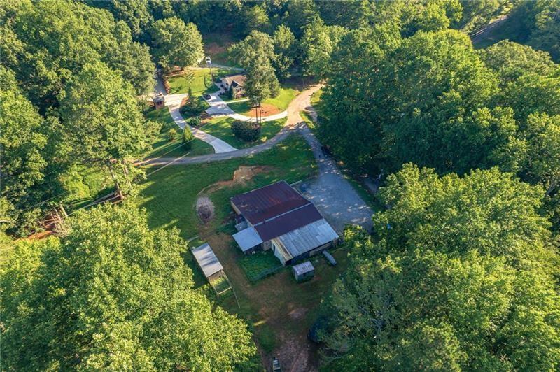 365 Russell King Lane Canton, GA 30115 - Photo 10 of 22 an aerial view of a house with a yard lake lake and mountain view in back