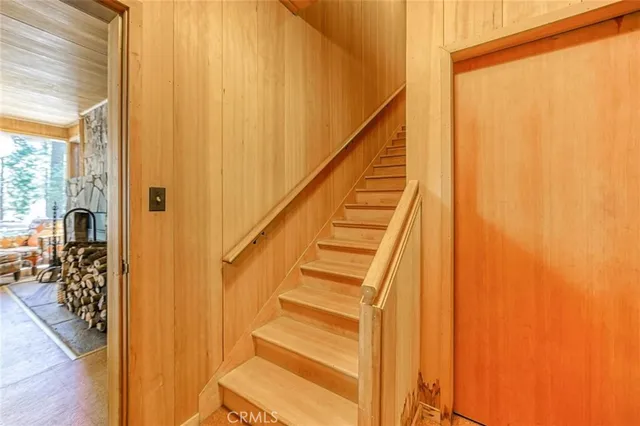 a view of entryway with wooden floor and livingroom view