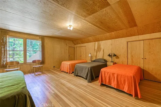 a bedroom with two beds and a large window